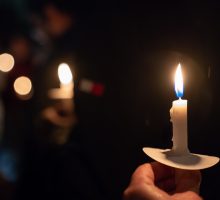 a lit candle in the dark